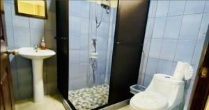 a bathroom with a shower with a toilet and a sink at Mountain Retreat in Bijagua de Upala with Stunning Nature Views in Bijagua