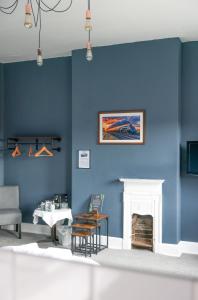 a living room with blue walls and a fireplace at Station Hotel in Hucknall