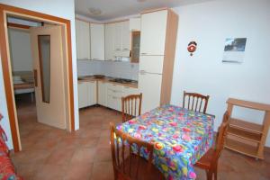 a kitchen with a table and a table and chairs at Cozy flat in Rosolina in Rosolina Mare