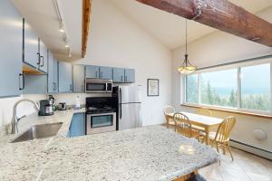 a kitchen with a counter and a table with chairs at Buffalo Ridge C302 in Silverthorne