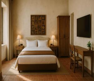 a bedroom with a bed and a desk and a television at Sidena Bovest in Rasa