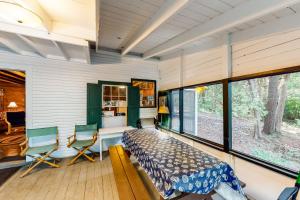 a bedroom with a bed and chairs in a room with windows at Garden Island's Cedar in Charlotte