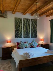 a bedroom with a bed with two lamps and a window at AGRITURISMO MODOLO Belluno Dolomiti in Belluno