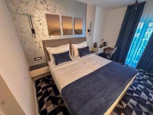 a bedroom with a large bed in a room at Hotel Modriča in Modriča