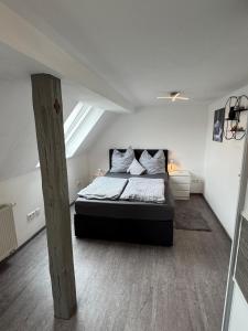 a bedroom with a large bed in a attic at Family & Work Apartment in Schopfloch +15 photos