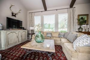 a living room with a couch and a table at Century Oak House - Main in Cranes Mill