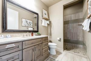 a bathroom with a sink and a toilet and a shower at Century Oak House - Main in Cranes Mill +13 photos