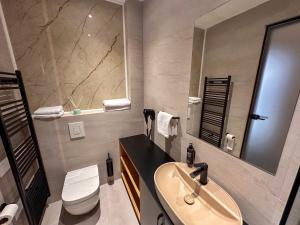 a bathroom with a sink and a toilet and a mirror at Hotel Modriča in Modriča +84 photos