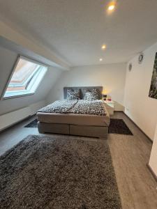 a bedroom with a bed in a room with a window at Family & Work Apartment in Schopfloch