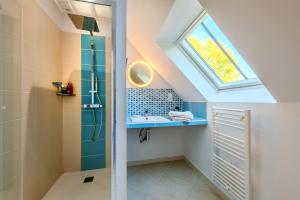 a bathroom with a skylight and a shower at Kergus - A 15 min de Morlaix in Plourin +3 photos
