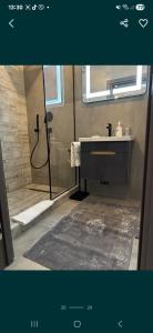 a bathroom with a shower and a sink at Квартира,Еврейская,1 in Bilhorod-Dnistrovskyi +4 photos