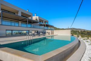 an image of a house with a swimming pool at Majo Luxury Villas Panoramic Sea View Retreat with Heated Private Pools & Gym & Sauna in Agia Pelagia