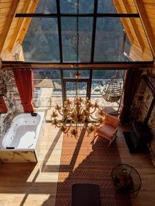 a large room with a tub and a large window at Walnut Bungalow in Çamlıhemşin
