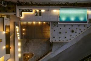 an overhead view of a building with a swimming pool at Majo Luxury Villas Panoramic Sea View Retreat with Heated Private Pools & Gym & Sauna in Agia Pelagia