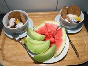 two plates of food on a wooden table with two bowls of food at Comfort Us 2 - Cozy Private Home in Uppsala
