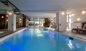 a large pool with blue water in a hotel at Ribas Karpaty in Bukovel