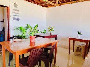 a wooden table and chairs in a room with plants at Solmar Beach Camp in San Vicente +102 photos
