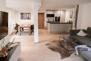 a living room with a couch and a table at HOLARI Appartement in Reith bei Seefeld