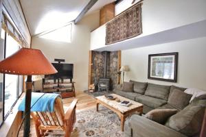 a living room with a couch and a table at 8 Leisure in Sunriver