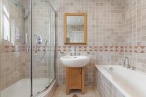 a bathroom with a sink and a shower and a tub at Garden Parking WiFi Near Sky Elstree Studios in Elstree +26 photos