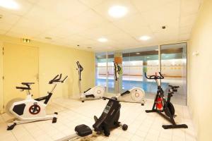 a gym with three exercise bikes in a room at Studio moderne à Ax-les-Thermes, 30 m² avec sauna in Ax-les-Thermes