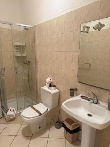 a bathroom with a toilet and a sink and a shower at Murdeira V159D Duplex by RPG Group in Beirona