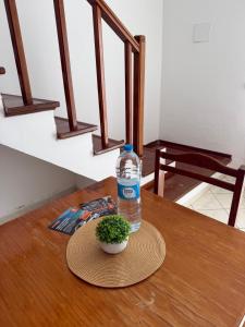 a bottle of water and a plant on a table at Murdeira V159D Duplex by RPG Group in Beirona +28 photos