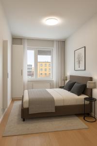 a bedroom with a large bed and two windows at Santa's Luxury Suite 3BDR, Sauna & Wifi in Rovaniemi