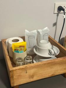 a wooden tray with food and toiletries on a table at Chalee Guest House in Ban Khlong Mat
