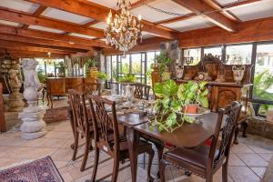 a dining room with a table and chairs and a chandelier at אחוזת בר in Sha'al