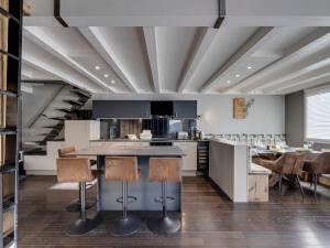 a kitchen with a table and some chairs at Tignes - Duplex rénové, 3 pièces, proche pistes, parking inclus - FR-1-641-115 in Tignes +6 photos