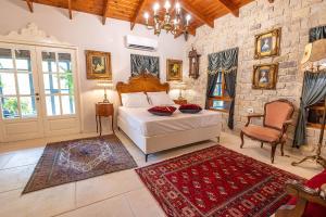 a bedroom with a bed and a stone wall at אחוזת בר in Sha'al