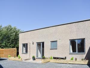 a brick building with a bench in front of it at Beckside House in Dalton in Furness +10 photos