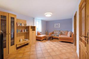 a living room with a couch and a chair at Pension Schmidt in Bad Brambach