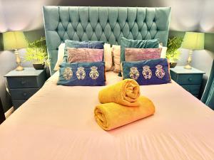 a bed with a towel on top of it at A Hidden Gem With Private Hot Tub and Garden - Netflix - Fast Wifi - Free Parking in Bournemouth +33 photos