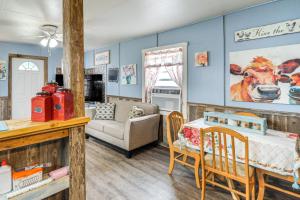 a living room with blue walls and a table and a couch at Walk to Lake Buchanan Cottage Near Wineries! in Buchanan Dam