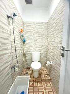 a bathroom with a toilet and a bath tub at Private Villa Near Nusa Dua Beach Bali in Nusa Dua