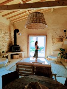 a woman is walking in a room with a window at AMEIO - Country House in Rio Maior