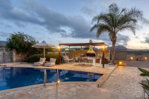 a villa with a swimming pool and a patio at Sunshine Villa with Private Pool by Estia in Hersonissos