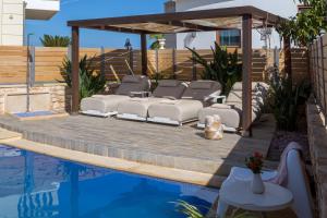 a gazebo next to a swimming pool at Sunshine Villa with Private Pool by Estia in Hersonissos