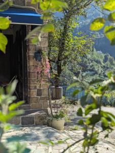 a brick house with a tree in a yard at Walnut Bungalow in Çamlıhemşin