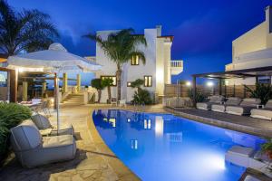a villa with a swimming pool at night at Sunshine Villa with Private Pool by Estia in Hersonissos