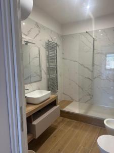 a bathroom with a white sink and a shower at Il Bijoux in Celano