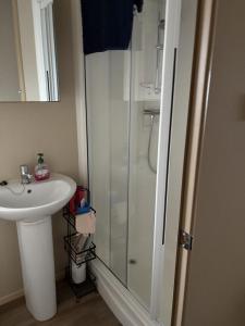 a bathroom with a shower and a sink at Caravan With Decking At Manor Park In Hunstanton, Sleeps 8 Ref 23046B in Hunstanton