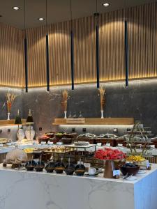 a kitchen with a bunch of food on a table at Bor Hotel by Karisma in Zlatibor