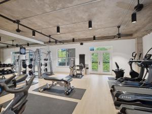 a gym with a lot of treadmills and machines at Kasa Downtown Austin in Austin