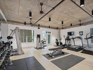 a gym with treadmills ellipticals and exercise machines at Kasa Downtown Austin in Austin