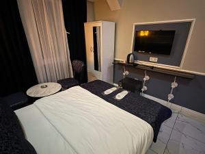 a hotel room with a bed and a flat screen tv at Bakırköy Otel in Istanbul +21 photos