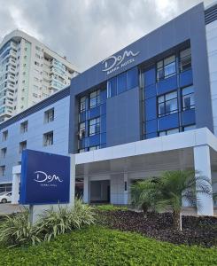 a blue building with a sign in front of it at DOM Barra Hotel in Rio de Janeiro