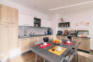 a kitchen with a table and chairs and a kitchen withktop at B&B alla Villa in Giovo